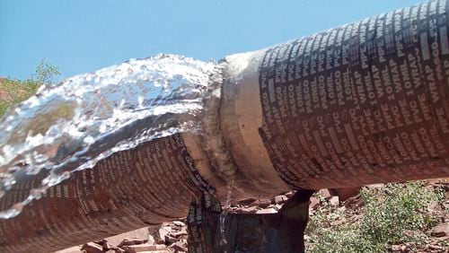 FILE - This undated photo provided by the National Park Service shows water spraying from a break in an exposed section of the Grand Canyon trans-canyon waterline. (National Park Service via AP, File)