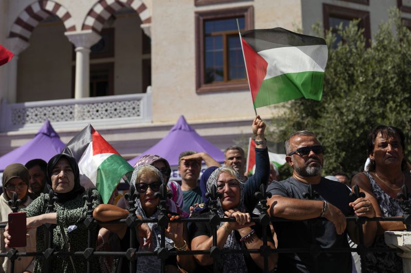 People hold Palestinian flags while attending the funeral of Aysenur Ezgi Eygi, a 26 year-old Turkish-American activist killed by the Israeli military, in Didim, Turkey, Saturday, Sept. 14, 2024,(AP Photo/Khalil Hamra)