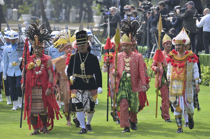 Participants in traditional attire and uniformed personnel stand in formation ahead of the ceremonial welcome for Pope Francis at the Presidential Palace in Jakarta Wednesday, Sept. 4, 2024. (Bay Ismoyo/Pool Photo via AP)