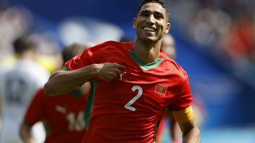 Morocco's Achraf Hakimi celebrates scoring his side's third goal during the quarterfinal men's soccer match between Morocco and the United States at the Parc des Princes during the 2024 Summer Olympics, Friday, Aug. 2, 2024, in Paris, France. (AP Photo/Aurelien Morissard)