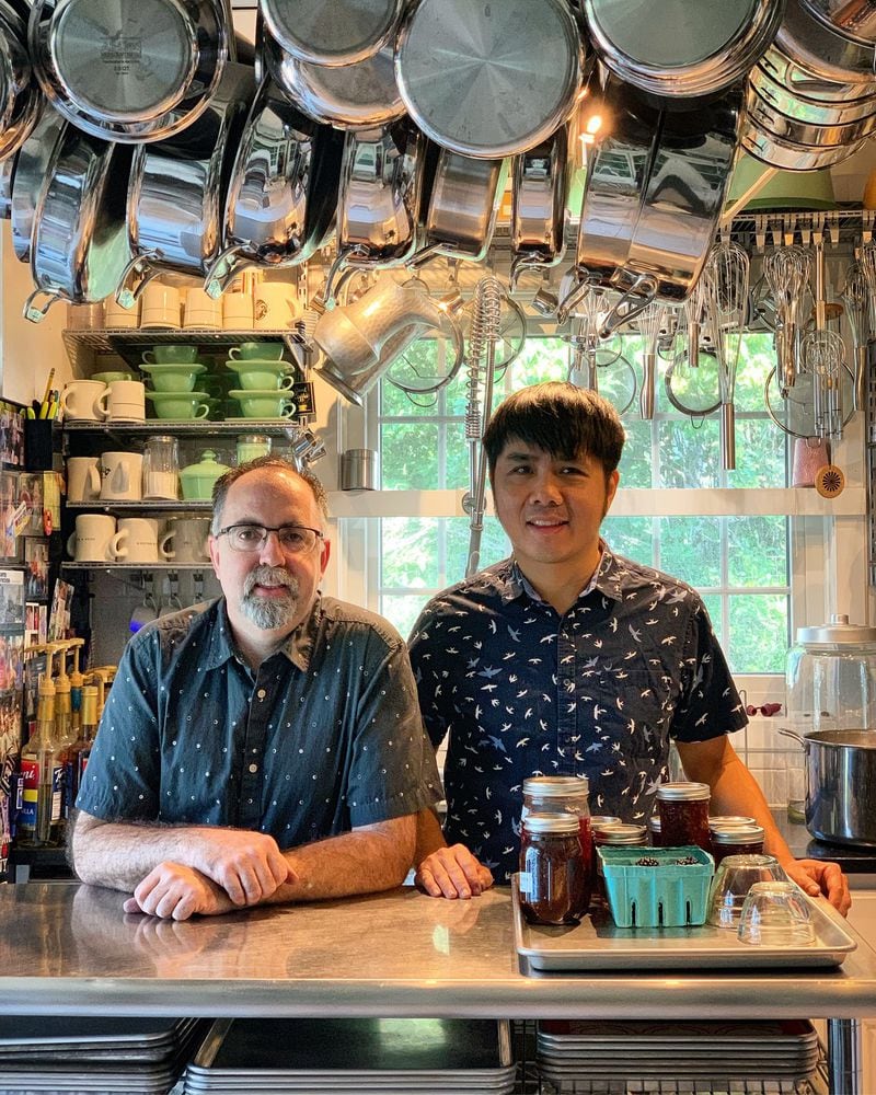 Dennis Landon (left) and Bernie Wong pause during a weeklong period in which they canned peaches in Wong’s home in Carrollton, Georgia. CONTRIBUTED BY ASHA GOMEZ