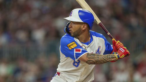 Atlanta Braves Eddie Rosario (8) eyes a pitch in the sixth inning of a baseball game against the Miami Marlins, Saturday, Aug. 3, 2024, in Atlanta. (AP Photo/Jason Allen)