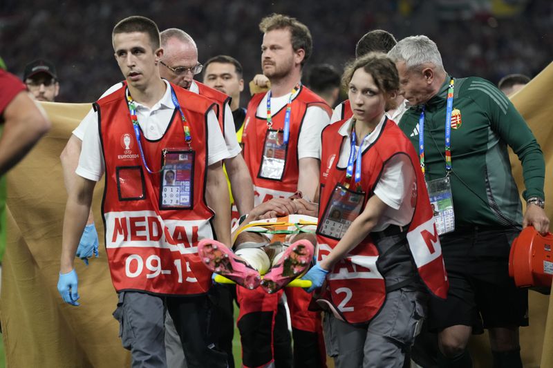 Hungary's Barnabas Varga leaves the pitch on a stretcher after he was injured during a Group A match between Scotland and Hungary at the Euro 2024 soccer tournament in Stuttgart, Germany, Sunday, June 23, 2024. (AP Photo/Antonio Calanni)