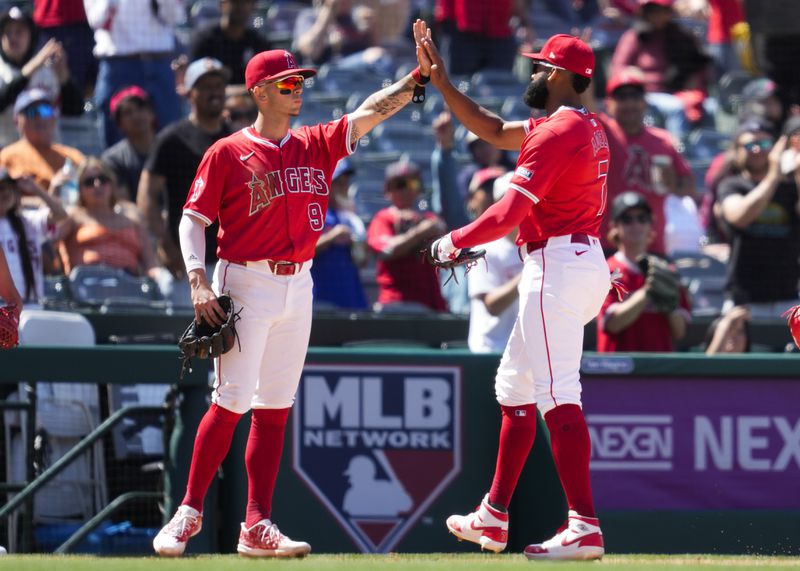 Los Angeles Angels right fielder Jo Adell (7) celebrates with shortstop Zach Neto (9) after catching a fly ball at the wall hit by Cleveland Guardians designated hitter José Ramírez during the eighth inning of a baseball game in Anaheim, Calif., Sunday, May 26, 2024. (AP Photo/Ashley Landis)
