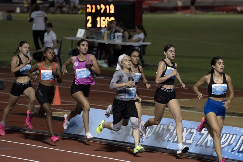 Beatie Deutsch, an Orthodox Jewish runner, fourth from right, competes in a 1500-meter run in Tel Aviv, Israel, Wednesday, June 26, 2024. (AP Photo/Maya Alleruzzo)
