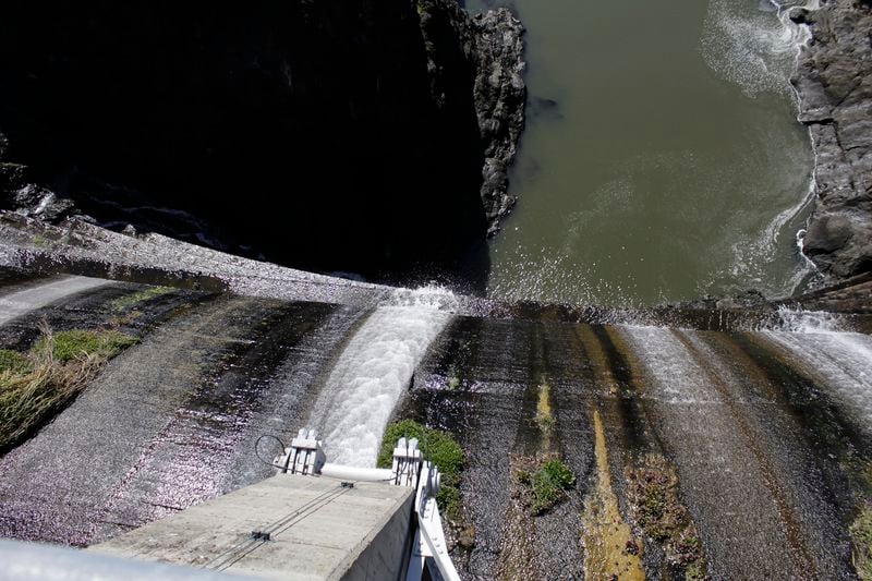 FILE - Excess water spills over the top of a dam on the Lower Klamath River known as Copco 1 near Hornbrook, Calif. (AP Photo/Gillian Flaccus, File)