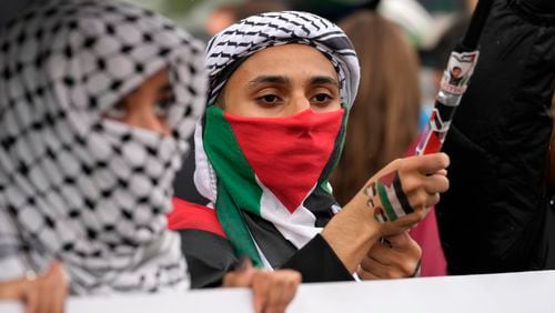 Women attend at a protest in Rome, Saturday, Oct. 5, 2024. Pro-palestinians people take to the street in an unauthorised march in the centre of Rome two days ahead of the first anniversary of the Oct. 7. (AP Photo/Andrew Medichini)