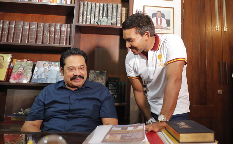 FILE - Sri Lankan Prime Minister Mahinda Rajapaksa speaks with his lawmaker son Namal following his election victory in the general election at his residence in Tangalle, Sri Lanka, Friday, Aug. 7, 2020.(AP Photo/Eranga Jayawardena, File)