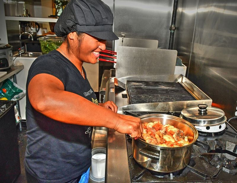 At the Estrellita restaurant in Grant Park, chef Blesseda Gamble (sister of co-owner Walter Cortado) prepares a dish they grew up with, called Afritada, a Filipino dish of a whole chicken cut up, with potatoes, peppers, tomatoes, garlic and onion served over jasmine rice. Chris Hunt for The Atlanta Journal-Constitution