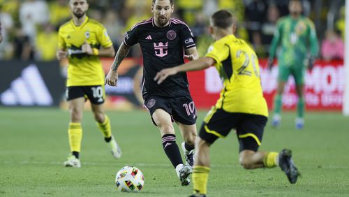 Inter Miami's Lionel Messi dribbles the ball as Columbus Crew's Alexandru Matan defends during the first half of an MLS soccer match Wednesday, Oct. 2, 2024, in Columbus, Ohio. (AP Photo/Jay LaPrete)