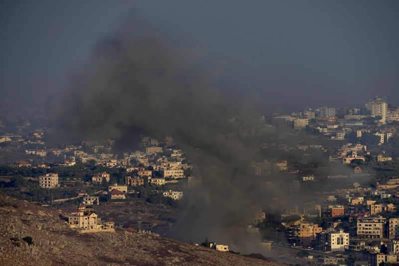 Smoke rises from an Israeli airstrike on Kfar Rouman village, as seen from Marjayoun town, south Lebanon, Monday, Sept. 23, 2024. (AP Photo/Hussein Malla)