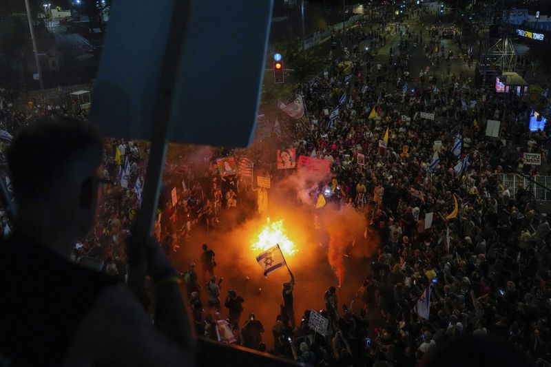 People protest against Prime Minister Benjamin Netanyahu's government and call for the release of hostages held in the Gaza Strip by the Hamas militant group, in Tel Aviv, Israel, Saturday, Sept. 7, 2024. (AP Photo/Ariel Schalit)