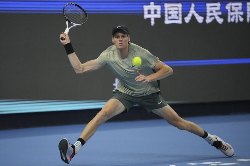 Jannik Sinner of Italy plays a forehand return against Carlos Alcaraz of Spain during their men's singles finals match of the China Open tennis tournament, at the National Tennis Center in Beijing, Wednesday, Oct. 2, 2024. (AP Photo/Achmad Ibrahim)