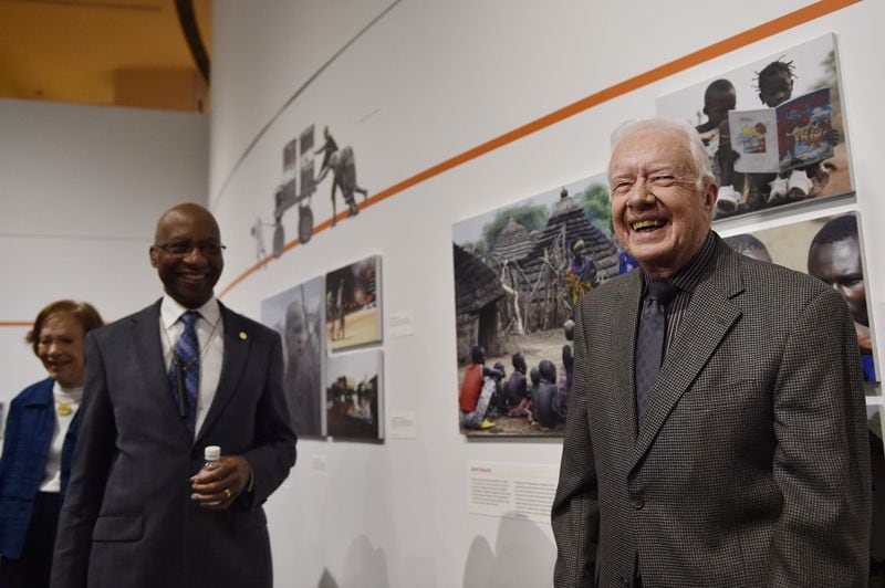 Former President Jimmy Carter, right, Dr. Donald Hopkins, center, and Rosalynn Carter, far left, give a tour of a new section of the Carter Museum. The Carter Center has aided in the near extinction of the Guinea worm where only 25 cases exist today. (DAVID BARNES / DAVID.BARNES@AJC.COM)