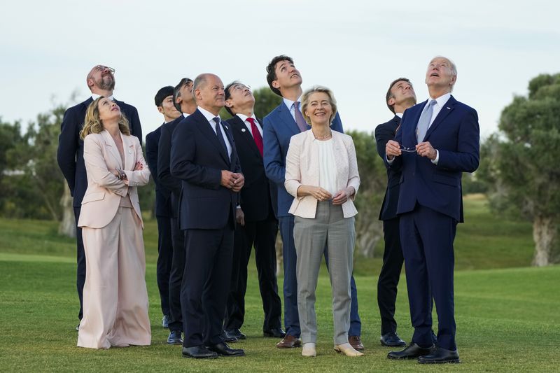 From right, U.S. President Joe Biden, French President Emmanuel Macron, European Commission President Ursula von der Leyen, Canada's Prime Minister Justin Trudeau, Japan's Prime Minister Fumio Kishida, German Chancellor Olaf Scholz, Britain's Prime Minister Rishi Sunak, Italian Prime Minister Giorgia Meloni and European Council President Charles Michel watch a skydiving demo during the G7 world leaders summit at Borgo Egnazia, Italy, Thursday, June 13, 2024. (AP Photo/Domenico Stinellis)