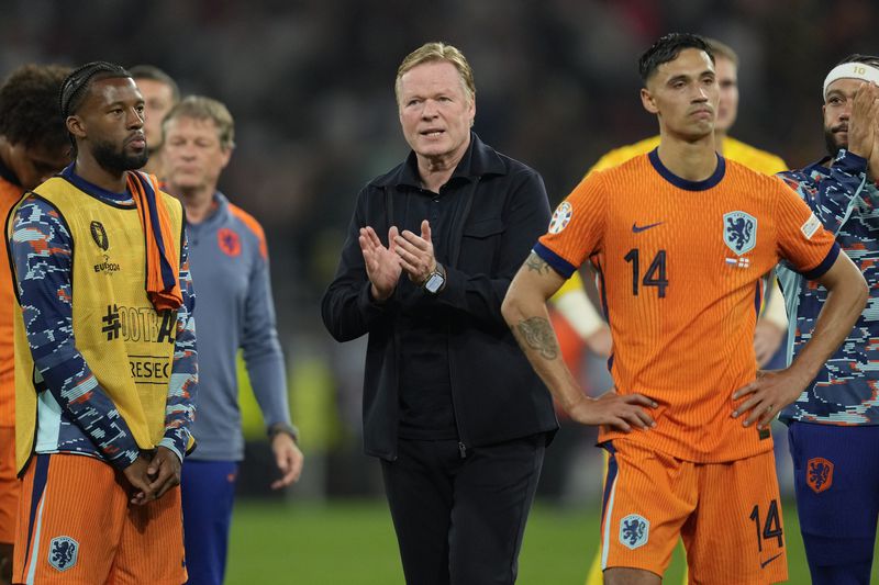 Netherlands head coach Ronald Koeman applauds supporters after a semifinal match between the Netherlands and England at the Euro 2024 soccer tournament in Dortmund, Germany, Wednesday, July 10, 2024. England won 2-1. (AP Photo/Darko Vojinovic)