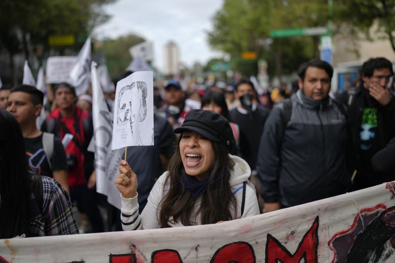 Demonstrators march to mark the 56th anniversary of the killing of student protesters at Tlatelolco plaza when soldiers opened fire on a peaceful demonstration, in Mexico City, Wednesday, Oct. 2. 2024. (AP Photo/Eduardo Verdugo)