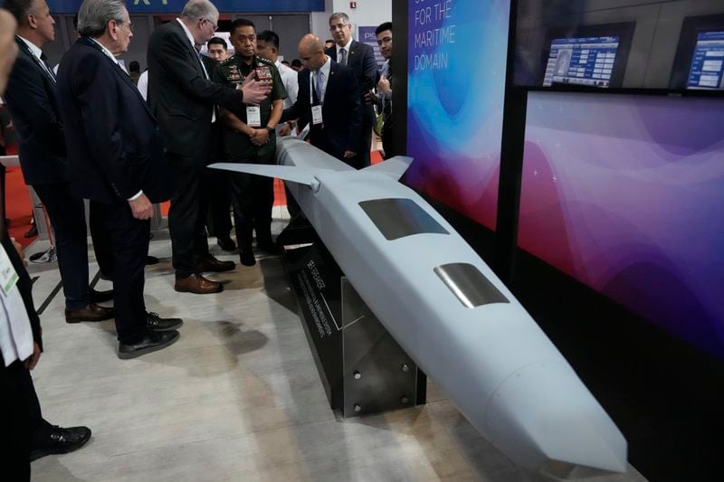 Philippine military chief Gen. Romeo Brawner Jr. center, listens as an exhibitor explains the Sea Breaker, a 5th gen long range naval and land missile system during the Asian Defense and Security Exhibition on Wednesday, Sept. 25, 2024, in Manila, Philippines. (AP Photo/Aaron Favila)