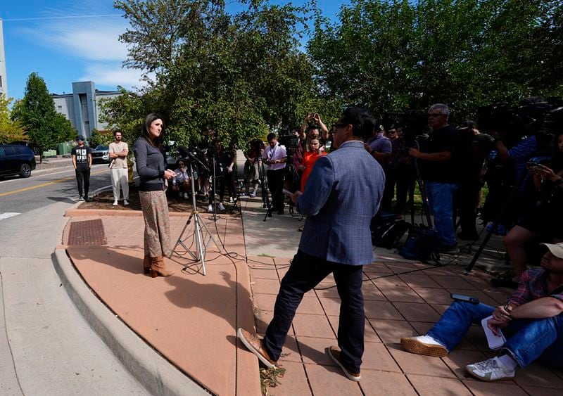 Rachel Haslett, left, spokesperson for the Broomfield, Colo., Police Department, responds to questions following a shooting at an apartment complex Thursday morning, Sept. 12, 2024, in Broomfield, Colo., a suburb of Denver. (AP Photo/David Zalubowski)