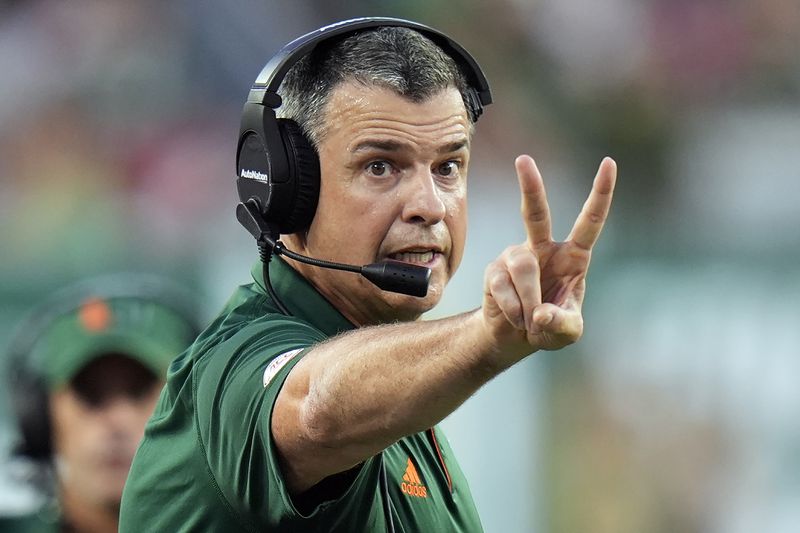 Miami head coach Mario Cristobal calls a play against South Florida during the first half of an NCAA college football game Saturday, Sept. 21, 2024, in Tampa, Fla. (AP Photo/Chris O'Meara)