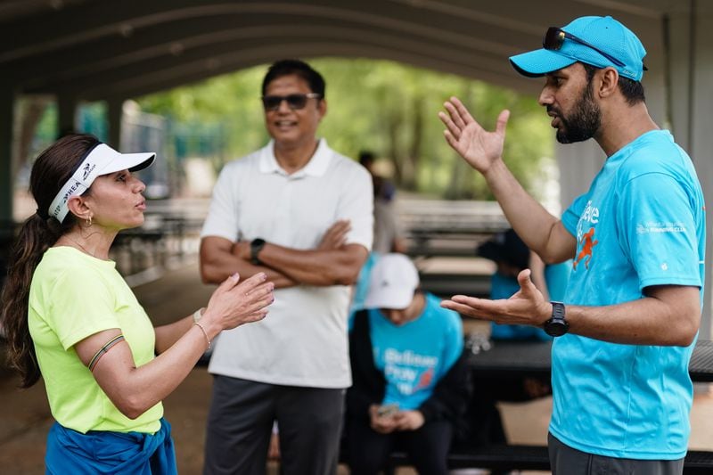 Atlanta Muslim Running Club member Arif Kazi, right, speaks with another member following a training run at Willeo Park. (Elijah Nouvelage for The Atlanta Journal-Constitution)