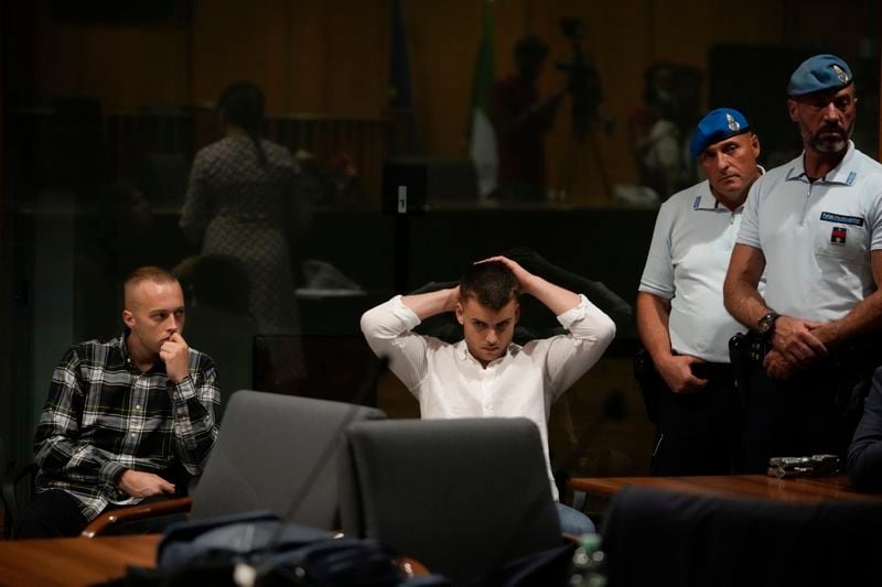 Finnegan Lee Elder, left, and Gabriel Natale Hjorth, sit before the reading of the judgment at the end of a hearing for the appeals trial in which they are facing murder charges for killing Italian Carabinieri paramilitary police officer Mario Cerciello Rega, in Rome, Wednesday, July 3, 2024. (AP Photo/Alessandra Tarantino)