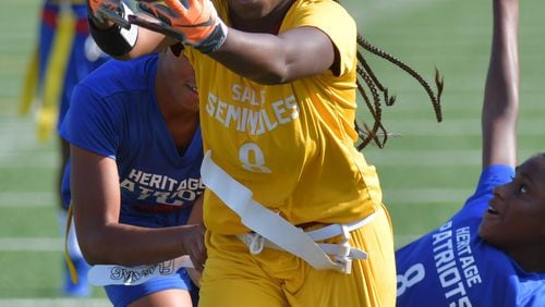 Salem’s Keyonna Brown runs the ball upfield during the girls flag football season opener against the Heritage at Salem High School in Conyers on Thursday, Sept. 12, 2019. HYOSUB SHIN / HYOSUB.SHIN@AJC.COM