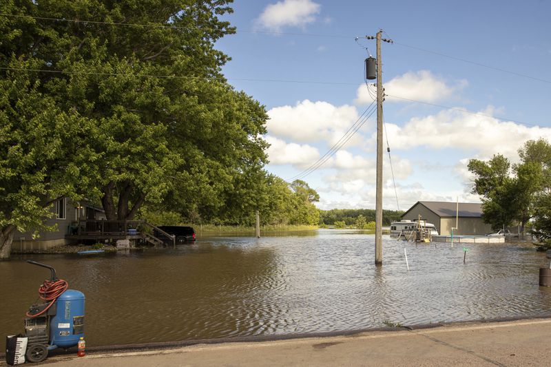 Floodwaters surround homes in Canton, S.D., Saturday, June 22, 2024, after days of heavy rain led to flooding in the area. (AP Photo/Josh Jurgens)