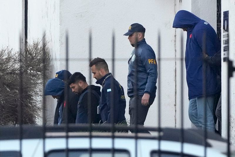 Police escort French rugby players Oscar Jegou, left, and Hugo Auradou, right, in Buenos Aires, Argentina, Thursday, July 11, 2024. The players were arrested following a formal complaint was filed against them for alleged sexual assault, after France played Argentina in a test rugby match in Mendoza on July 6. (AP Photo/Natacha Pisarenko)