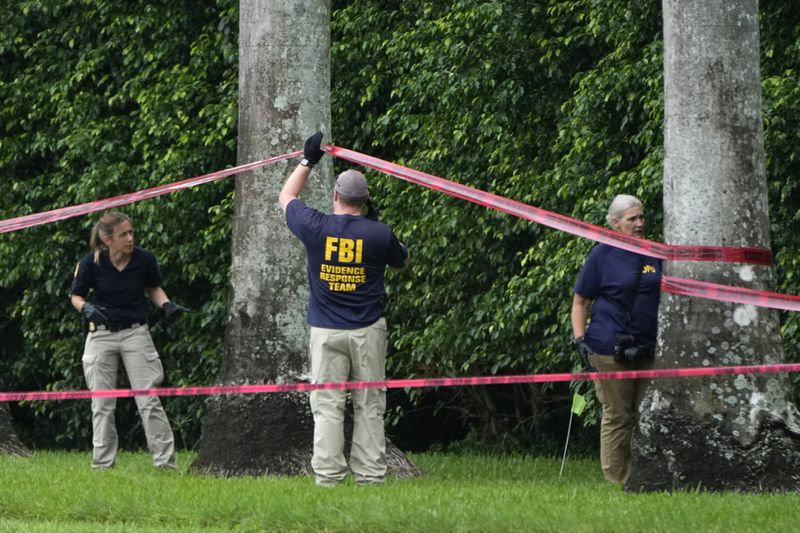 Law enforcement officials work at the scene of the Trump International Golf Club in the aftermath of the apparent assassination attempt of Republican presidential nominee and former President Donald Trump Tuesday, Sept. 17, 2024, in West Palm Beach, Fla. (AP Photo/Lynne Sladky)