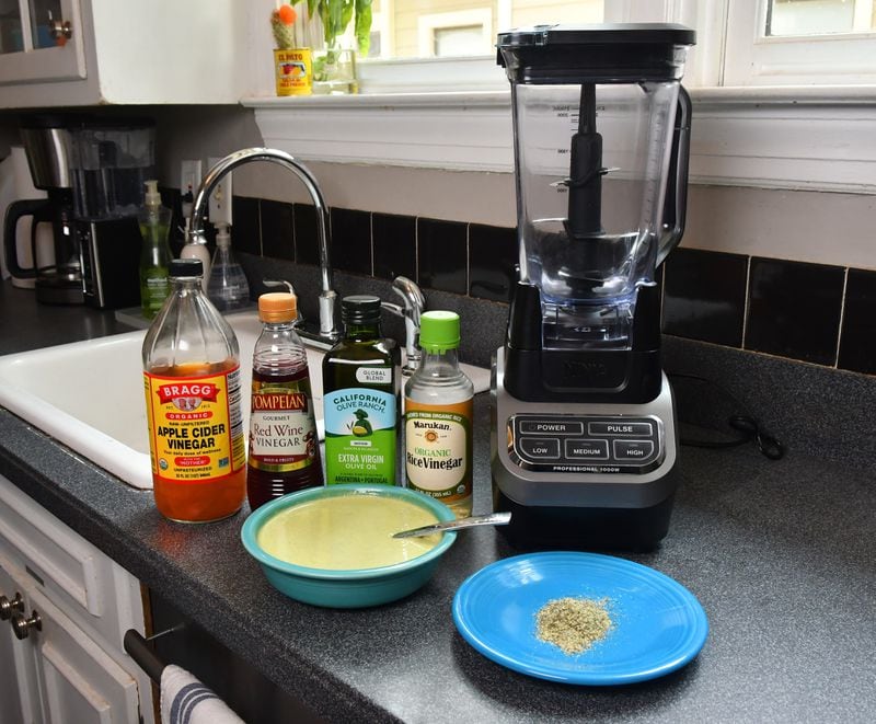 Nick Melvin often reaches for vinegars and oils, and he considers ranch dressing seasoning packets (bottom right) highly underrated. A Vitamix blender is among his essential kitchen gadgets and Poco Goddess Verde (bottom left) is a go-to salad dressing or simple snack with tortilla chips. (CHRIS HUNT FOR THE ATLANTA JOURNAL-CONSTITUTION)