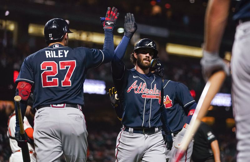 Atlanta Braves' Dansby Swanson celebrates with Austin Riley, left, after hitting a two-run home run against the San Francisco Giants during the third inning of a baseball game in San Francisco, Tuesday, Sept. 13, 2022. (AP Photo/Godofredo A. Vásquez)