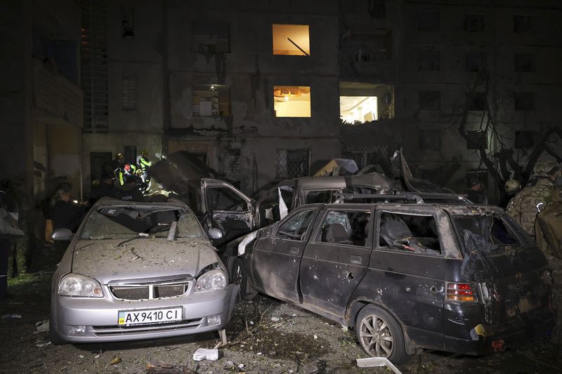 Emergency services workers move rubble after a Russian strike on a residential building in Kharkiv, Ukraine early Sunday Sept. 22, 2024. (Kharkiv Regional Military Administration via AP)