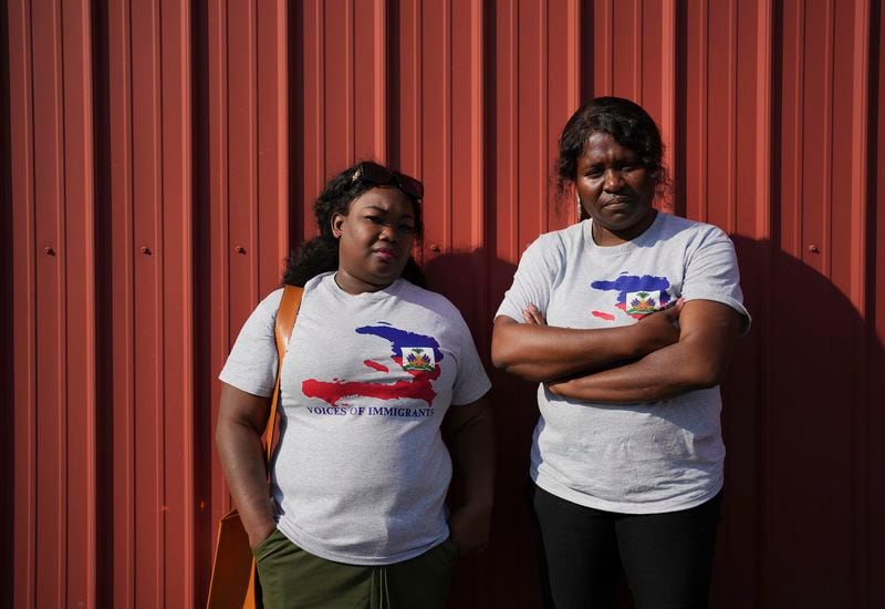 Mia Perez, left, an immigration lawyer, and Bernardette Dor, a pastor at the First Haitian Church, pose for a photo together after joining a prayer walk in support of their Haitian immigrant community in Springfield, Ohio, Saturday, Sept. 14, 2024. (AP Photo/Luis Andres Henao)