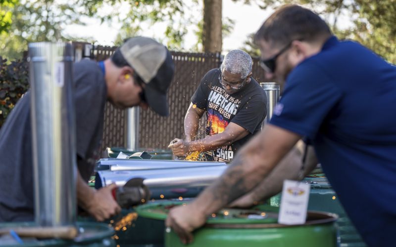 International Aerospace Machinists member Clint Moore, center, builds burn barrels with fellow union members in preparation for strike if members recject a contract offer by airplane maker Boeing, on Thursday, Sept. 12, 2024, in Seattle. (AP Photo/Stephen Brashear)