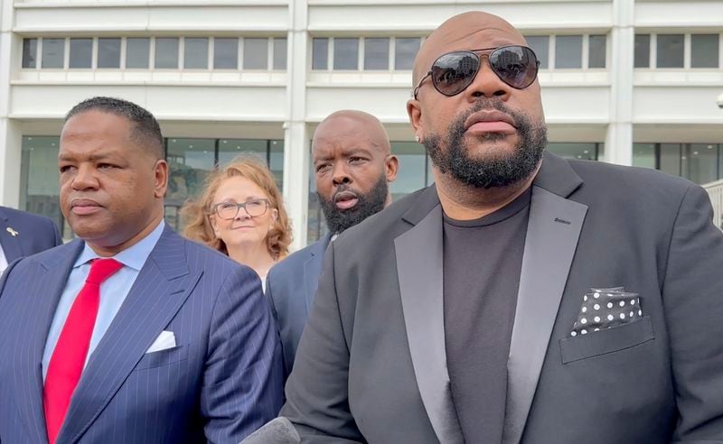 Isaac Hayes III, right, and his attorney address reporters outside a federal courthouse in Atlanta, Tuesday, Sept. 3, 2024. (AP Photo/Kate Brumback)