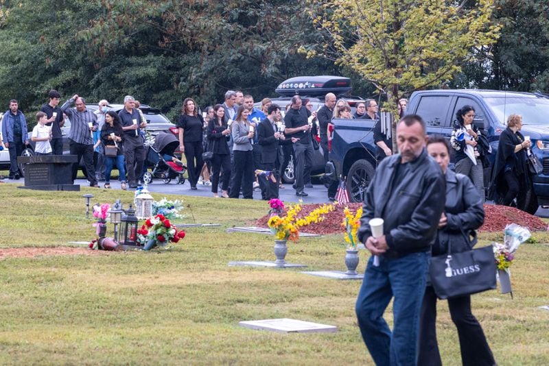 Mourners follow the casket of Ana Cristina Irimie, a math teacher killed at Apalachee High School during a school shooting, to the burial site after her funeral service at Hamilton Mill Memorial Chapel and Gardens in Buford on Saturday, September 14, 2024. (Arvin Temkar / AJC)