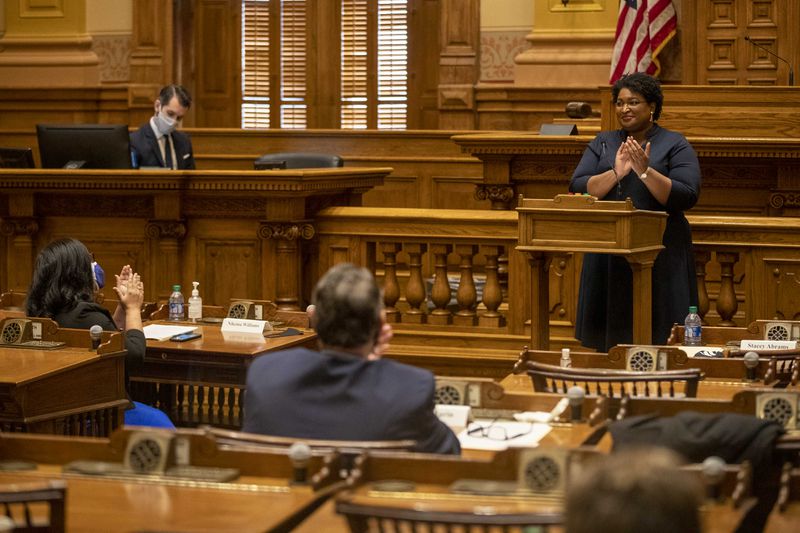 12/14/2020   Atlanta, Georgia   Georgia Democrat Stacey Abrams joins in applause after she and other members of Georgias Electoral College cast their ballots in the Georgia Senate Chambers at the Georgia State Capitol building in Atlanta, Monday, December 14, 2020.  (Alyssa Pointer / Alyssa.Pointer@ajc.com)