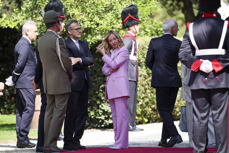 Italian Prime Minister Giorgia Meloni, center, waits for British Prime Minister Keir Starmer to arrive for a a welcome ceremony on the occasion of his visit, at Villa Doria Pamphilj, in Rome, Monday, Sept. 16, 2024. (Phil Noble/Pool Photo via AP)