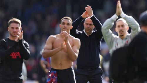 Liverpool's manager Arne Slot, centre right, celebrates with players after the English Premier League soccer match between Crystal Palace and Liverpool at Selhurst Park in London, Saturday, Oct. 5, 2024.(AP Photo/Ian Walton)