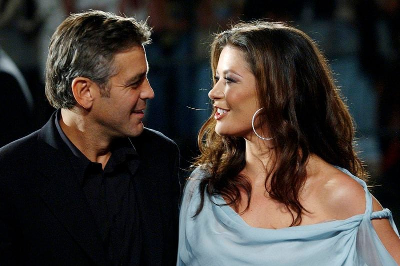 FILE - US actor George Clooney, left, and Welsh actress Catherine Zeta-Jones appear at the screening of their film "Intolerable Cruelty" out of competition at the 60th Venice Film Festival in Venice, Italy, Wednesday, Sept. 3, 2003. (AP Photo/Luca Bruno, File)