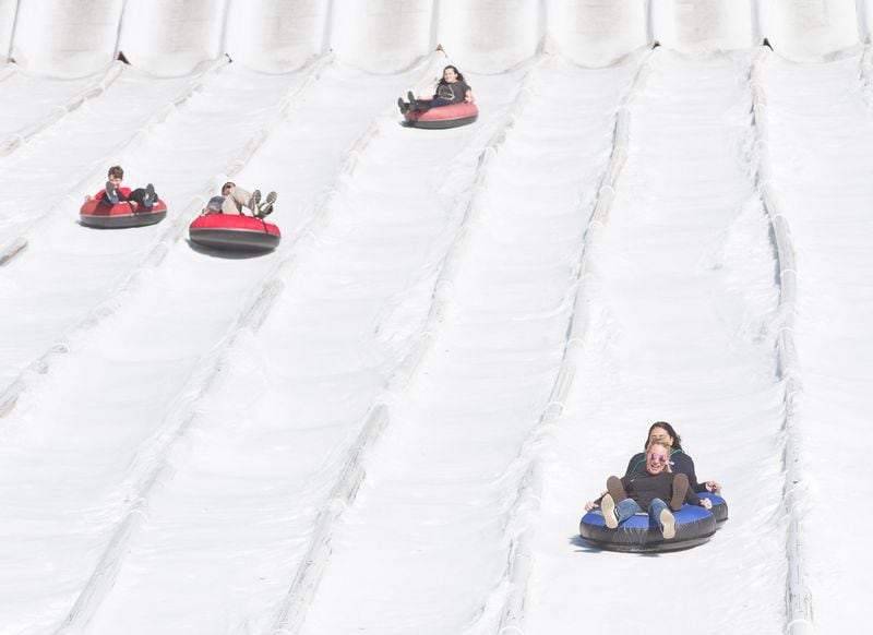People head down the 400-foot tubing hill at Snow Mountain in Stone Mountain Park in this file photo. STEVE SCHAEFER / SPECIAL