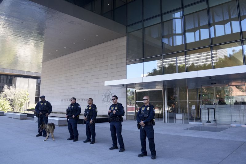 Police officers guard the entrance to a federal courthouse after Hunter Biden pleaded guilty in his felony federal tax case, Thursday, Sept. 5, 2024, in Los Angeles. (AP Photo/Eric Thayer)