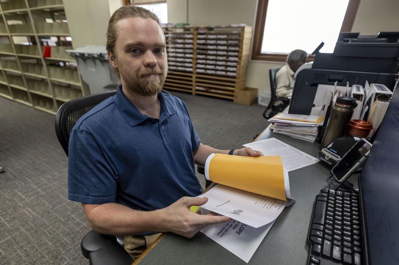 Trey Forrest, Absentee Election Coordinator for the Jefferson County/Birmingham (Ala) Division, prepares absentee ballots for the November election, Tuesday, Sept. 10, 2024, in Birmingham, Ala. (AP Photo/Vasha Hunt)