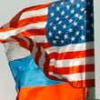 FILE - U.S. and Russian national flags wave on the wind in Moscow's Vnukovo airport, Russia, April 11, 2017 to welcome a U.S. dignitary. (AP Photo/ Ivan Sekretarev, file)