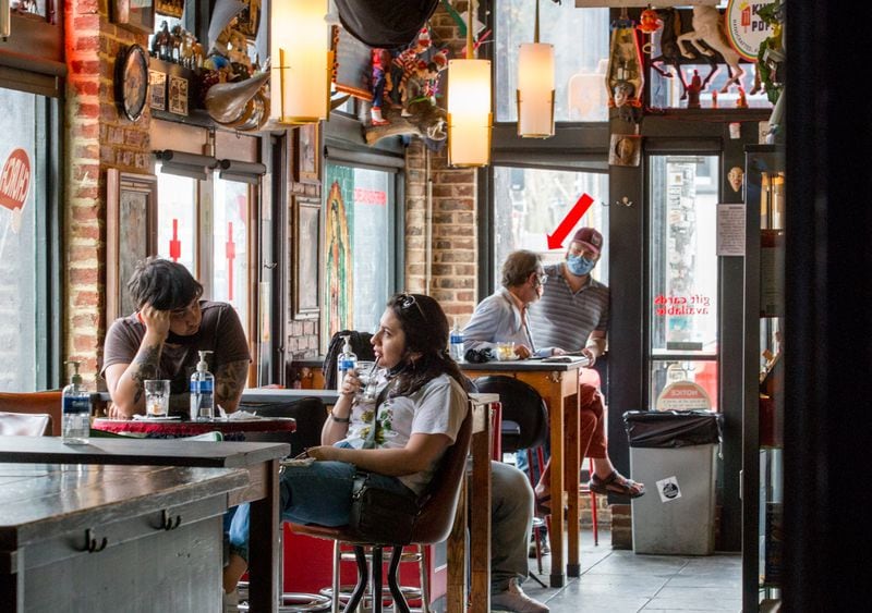 Patrons grab a drink at Church on a recent Friday evening. (Jenni Girtman for The Atlanta Journal-Constitution)