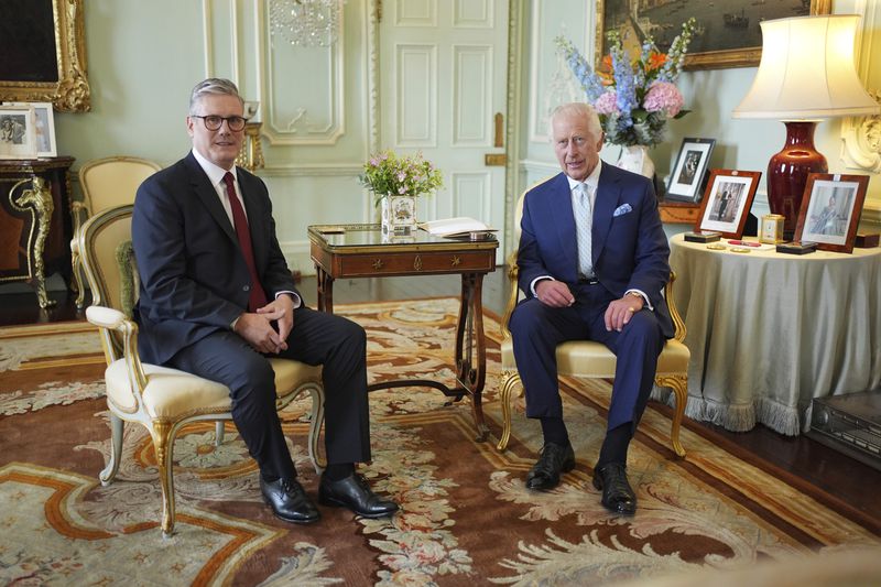 Britain's King Charles III, right, sits during an audience with Keir Starmer where he invited the Labour Party leader to become prime minister and to form a new government, following the landslide general election victory for the Labour Party, in London, Friday, July 5, 2024. (Yui Mok, Pool Photo via AP)