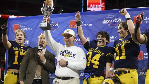 Prince Avenue Christian head coach Greg Vandagriff lifts the trophy after their 49-32 win against Swainsboro in the Class A Division I GHSA State Championship game at Mercedes-Benz Stadium, Monday, December. 11, 2023, in Atlanta. (Jason Getz / Jason.Getz@ajc.com)