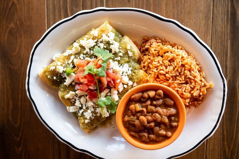 Dos Bocas Enchilada Verde, three chicken enchiladas, salsa verde, sour cream, queso cotija, pico de gallo, served with rice and charro beans. Photo credit- Mia Yakel.