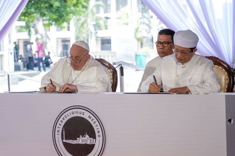 Pope Francis and the Grand Imam Nasaruddin Umar, right, sign the "Joint Declaration of Istiqlal 2024" as they meet at the Istiqlal Mosque in Jakarta, Thursday, Sept. 5, 2024. Pope Francis urged Indonesia to live up to its promise of "harmony in diversity" and fight religious intolerance on Wednesday, as he set a rigorous pace for an 11-day, four-nation trip through tropical Southeast Asia and Oceania. (AP Photo/Gregorio Borgia)